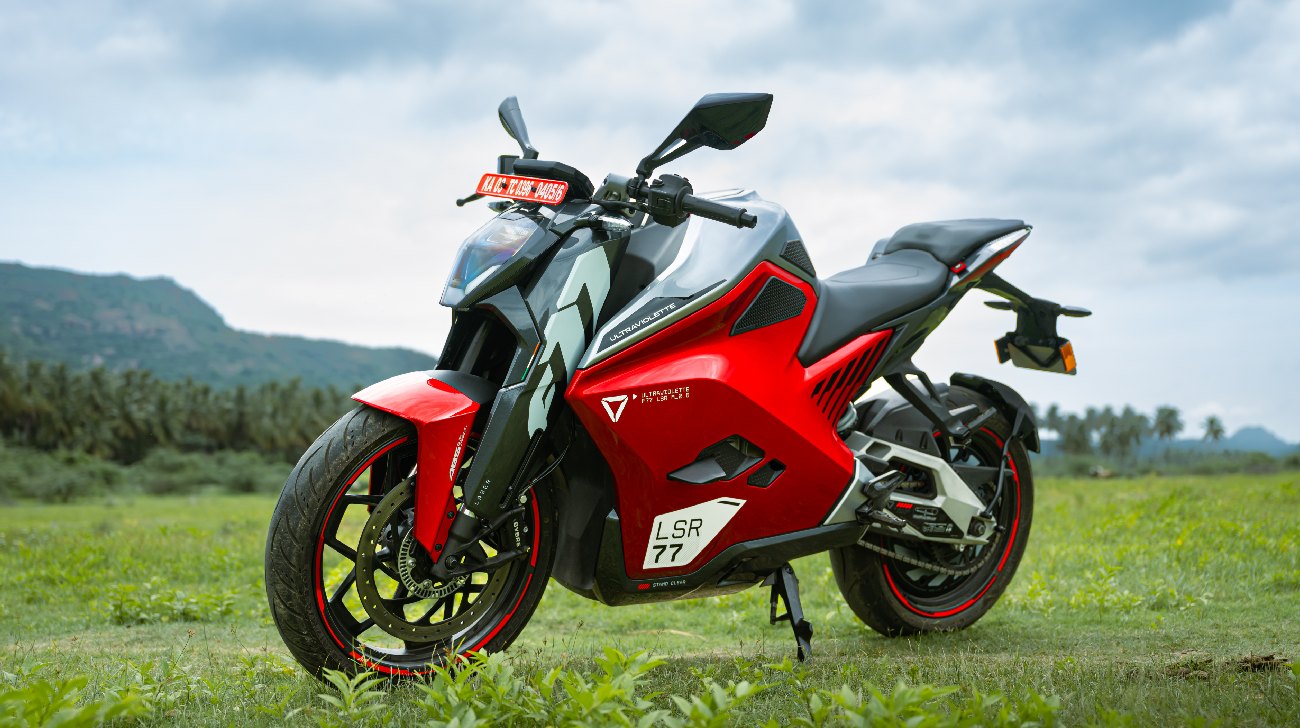 A Red Ultraviolette F77 Mach 2 On A Lush Green Fieldjpg